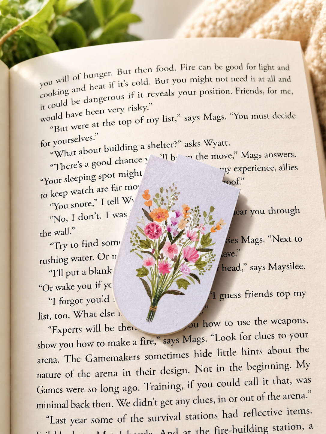 Wildflower magnetic bookmark placed on open book creating soft reading aesthetic