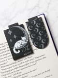 Moon cat magnetic bookmark and matching patterned bookmark placed inside an open book