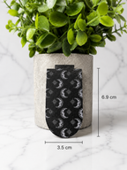 Black magnetic bookmark with moon and star pattern shown with measurements 6.9 cm by 3.5 cm