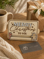 Wooden Christmas gift card holder displayed with mug and wrapped gift in festive setting