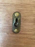 Small metal lock mechanism on a wooden surface