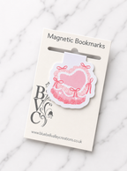Pink coquette style heart magnetic bookmark attached to branded Bluebell Valley Creations packaging card, showing retail presentation on a marble background