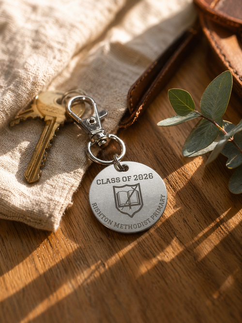 Personalised Class of 2026 keychain on wooden surface with keys, fabric and greenery, lifestyle product image