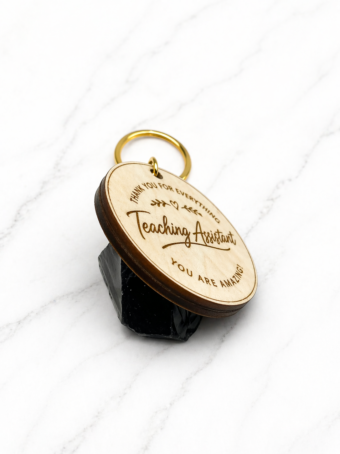 Custom engraved wooden teaching assistant keyring shown at angle with gold keyring chain detail