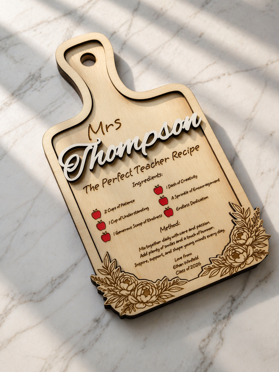 Personalised wooden teacher recipe plaque with engraved text and raised name detail in natural light