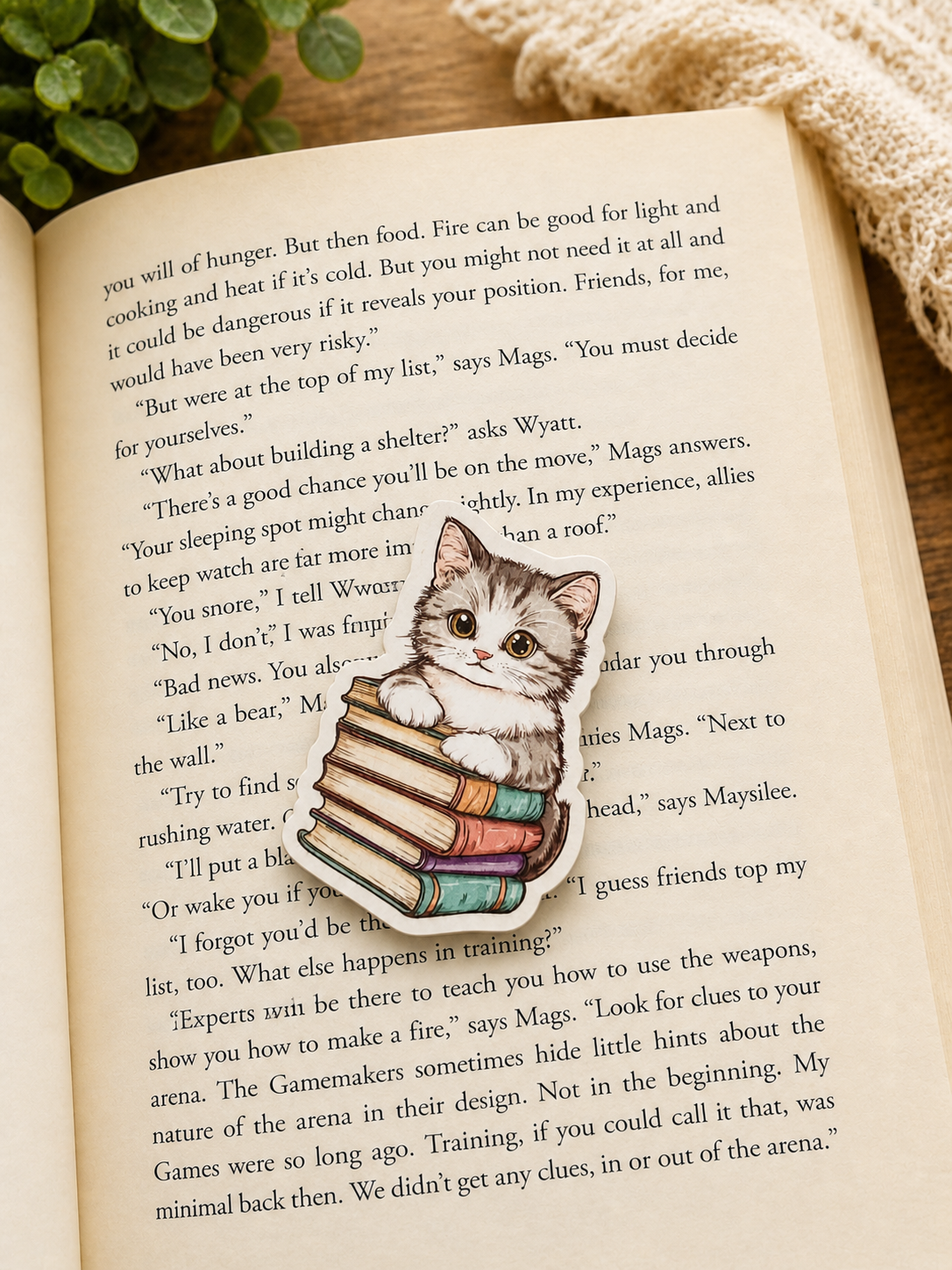 Adorable kitten bookmark resting on open book in soft lighting