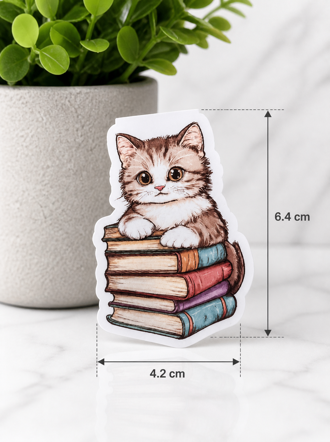 Kitten magnetic bookmark on books showing size 6.4cm by 4.2cm