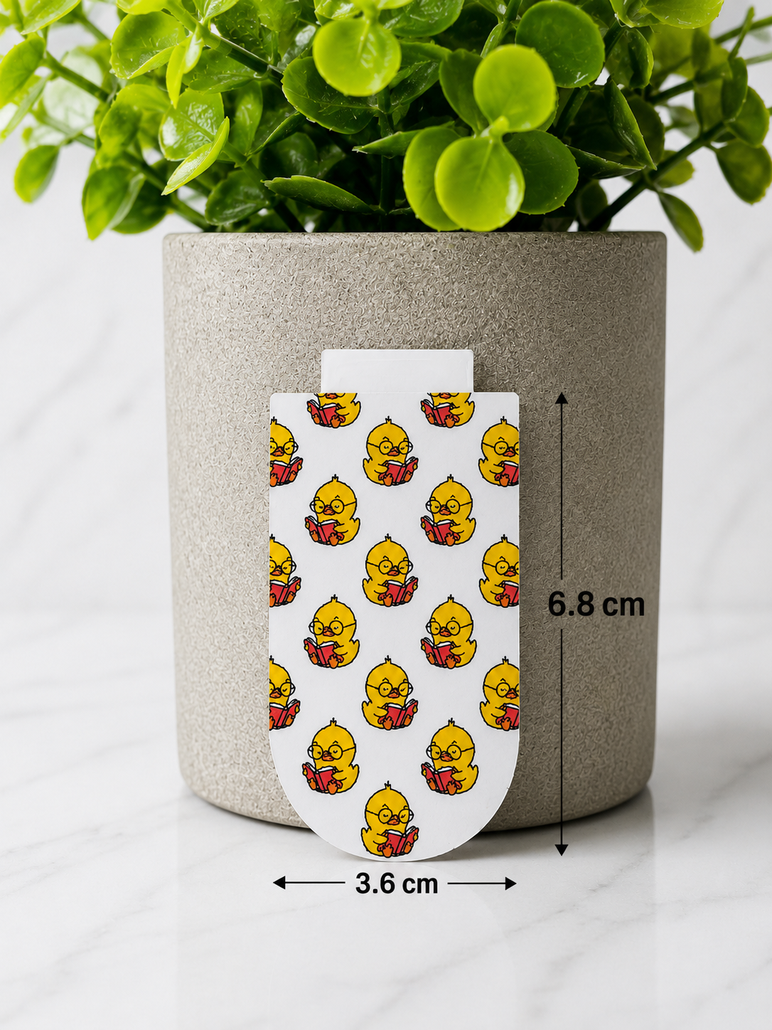 Magnetic bookmark with repeating chick reading pattern shown with dimensions 6.8 cm by 3.6 cm