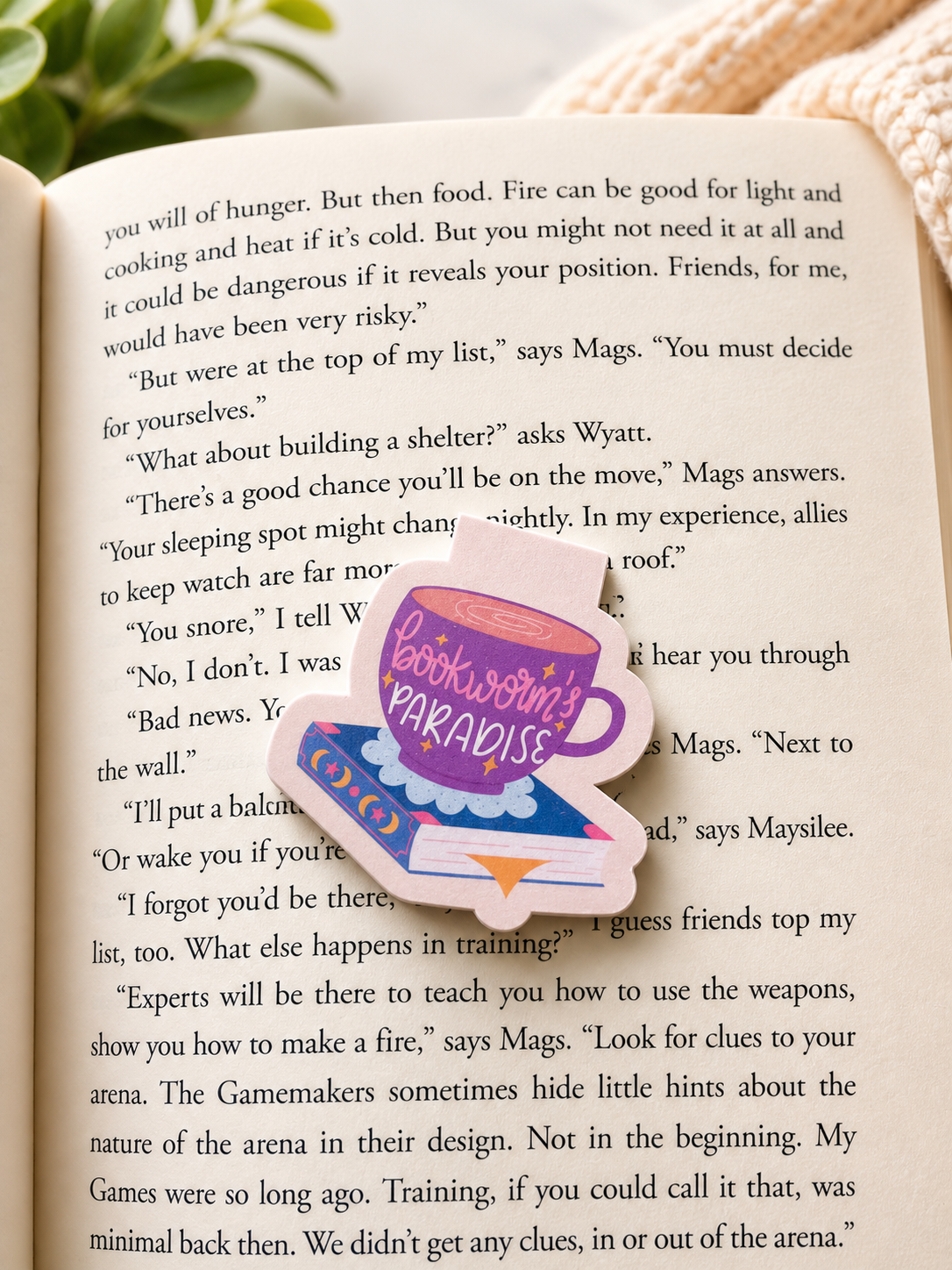 Bookworm paradise magnetic bookmark placed on open book with soft reading setup