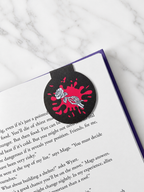 Gothic magnetic bookmark with skeleton rose design placed on book corner