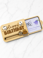 Angled view of wooden birthday gift card holder showing engraved text and decorative elements