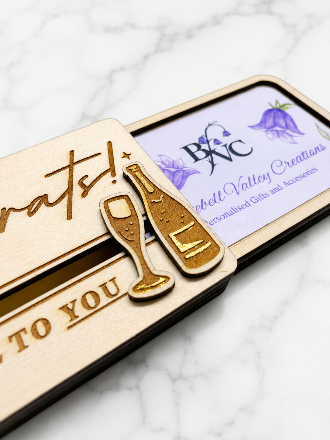 Wooden congratulations gift card holder showing sliding mechanism and inserted gift card