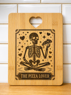 Rectangular bamboo chopping board with skeleton pizza lover engraving and heart handle against white tiled wall