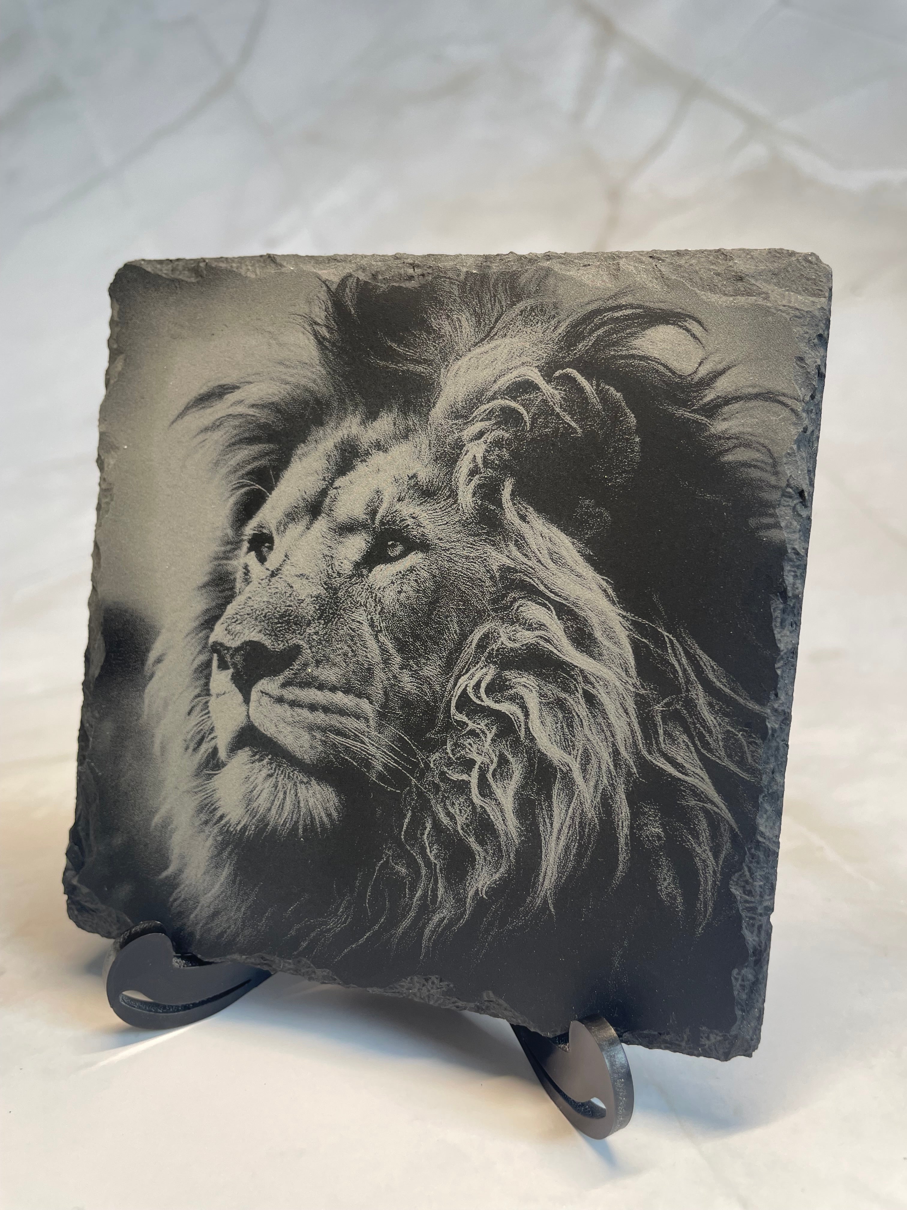 Decorative slate with a lion engraving on a white surface