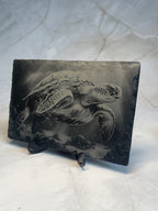 Decorative engraved slate with a turtle design on a marble surface