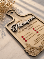 Close up of engraved wooden teacher plaque with floral border and personalised name detail