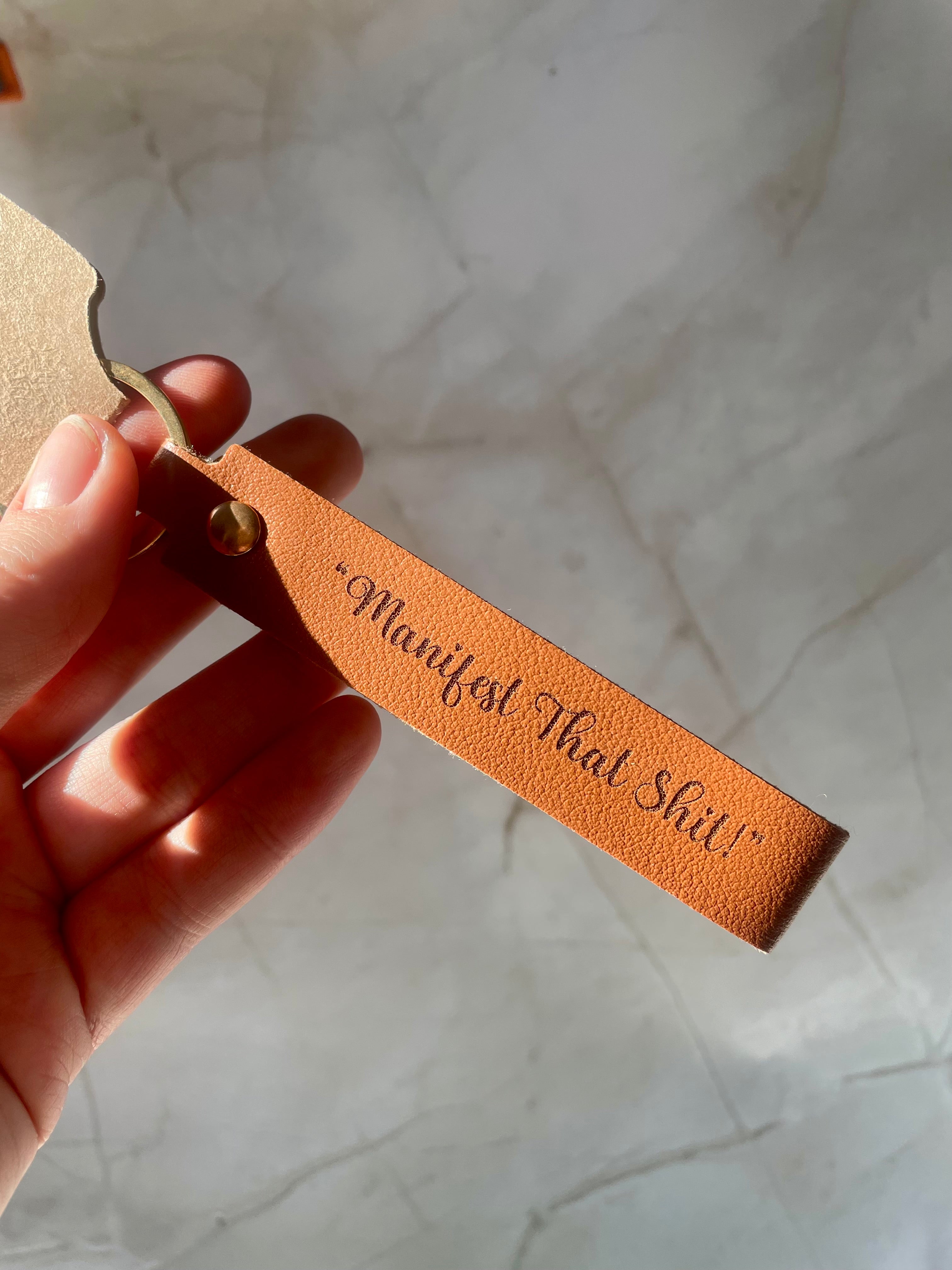 “Manifest That Shit” Engraved Faux Leather Keychain – Motivational Keyring