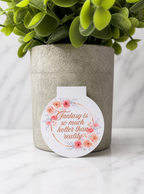 Floral magnetic bookmark featuring soft pink and peach flowers surrounding the quote “Fantasy is so much hotter than reality” in elegant script, designed for romance and fantasy book lovers