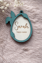 Wooden Easter tag with a bunny holding an egg. the outline is stained forest green. Written inside the egg are 'Sarah' and 'Happy Easter'.
