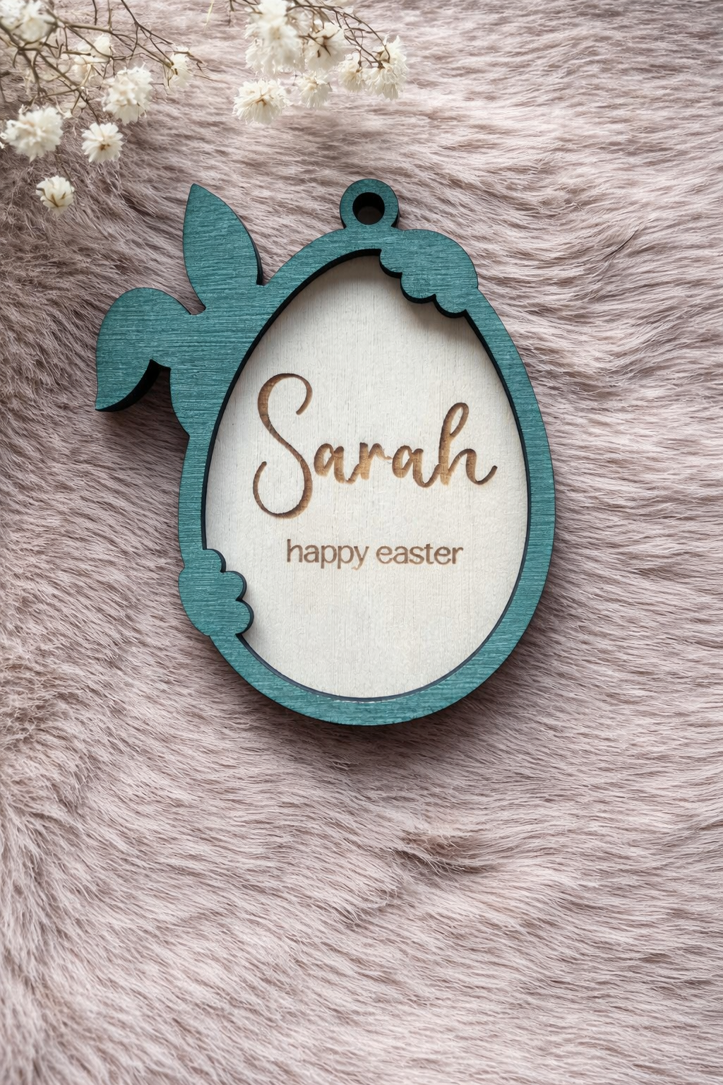 Wooden Easter tag with a bunny holding an egg. the outline is stained forest green. Written inside the egg are 'Sarah' and 'Happy Easter'.