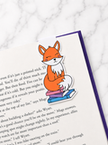 Cute fox magnetic bookmark clipped onto a book page showing use as a page holder