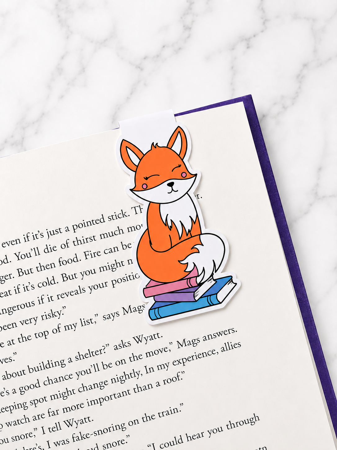 Cute fox magnetic bookmark clipped onto a book page showing use as a page holder
