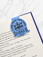 Close up of magnetic bookmark with gothic fairytale quote on open book page
