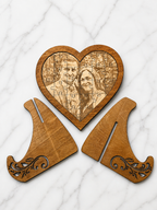 Flat lay of wooden heart photo puzzle with engraved image and separate display stand pieces