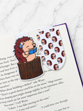 Two hedgehog magnetic bookmarks clipped onto book pages showing both character and pattern designs in use
