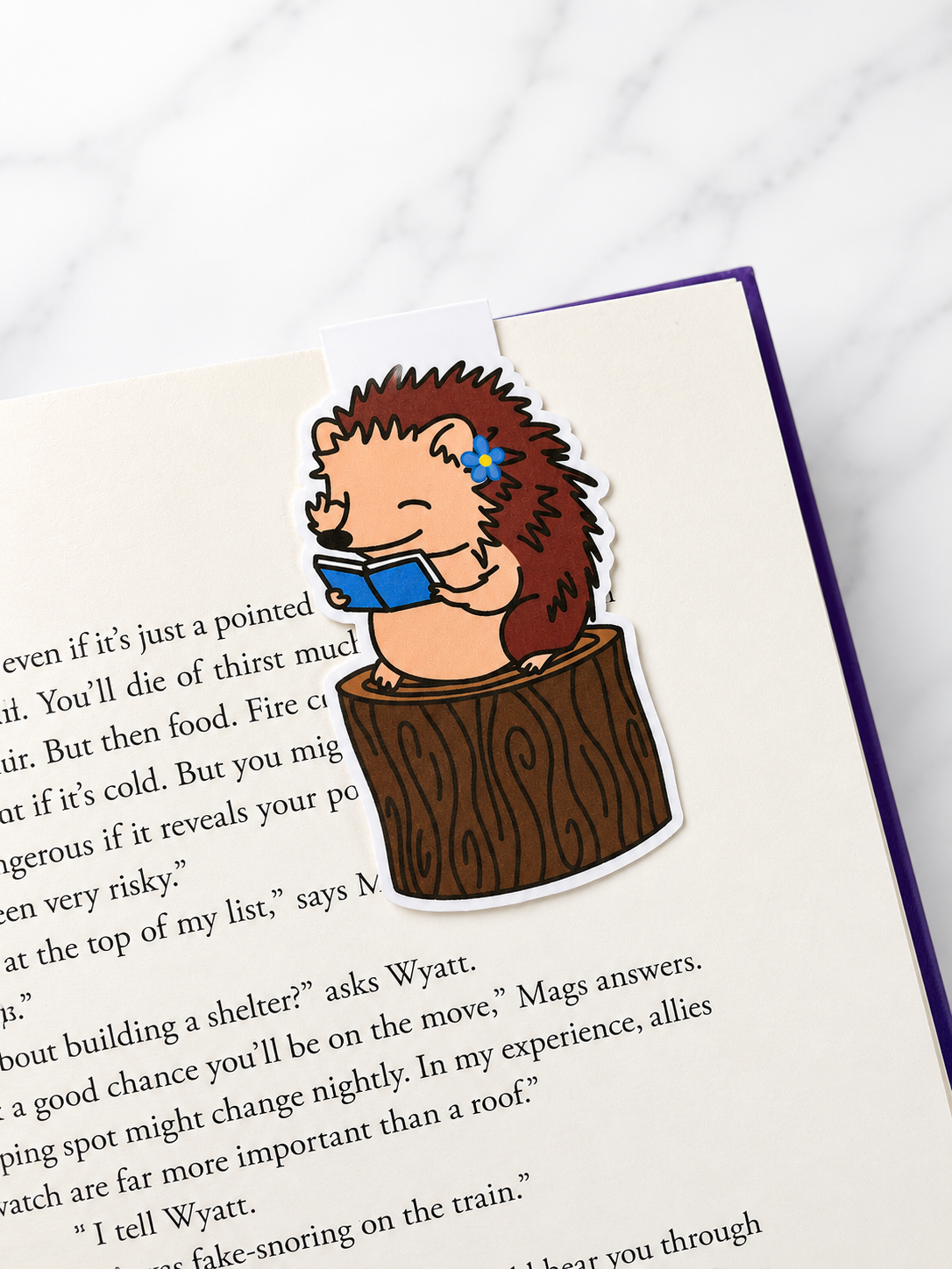 Cute hedgehog magnetic bookmark clipped onto a book page showing use as a page holder