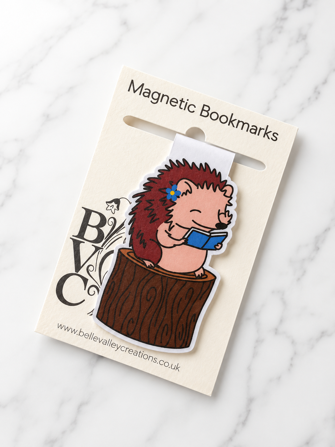Hedgehog magnetic bookmark displayed on Bluebell Valley Creations branded packaging on a marble background