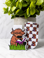 Set of two magnetic bookmarks featuring a Highland cow reading design and matching pattern version displayed together on a marble background