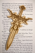 Laser engraved sword bookmark placed on book for reading accessory