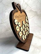 Side view of layered wooden apple plaque showing depth and raised student name pieces on engraved teacher gift
