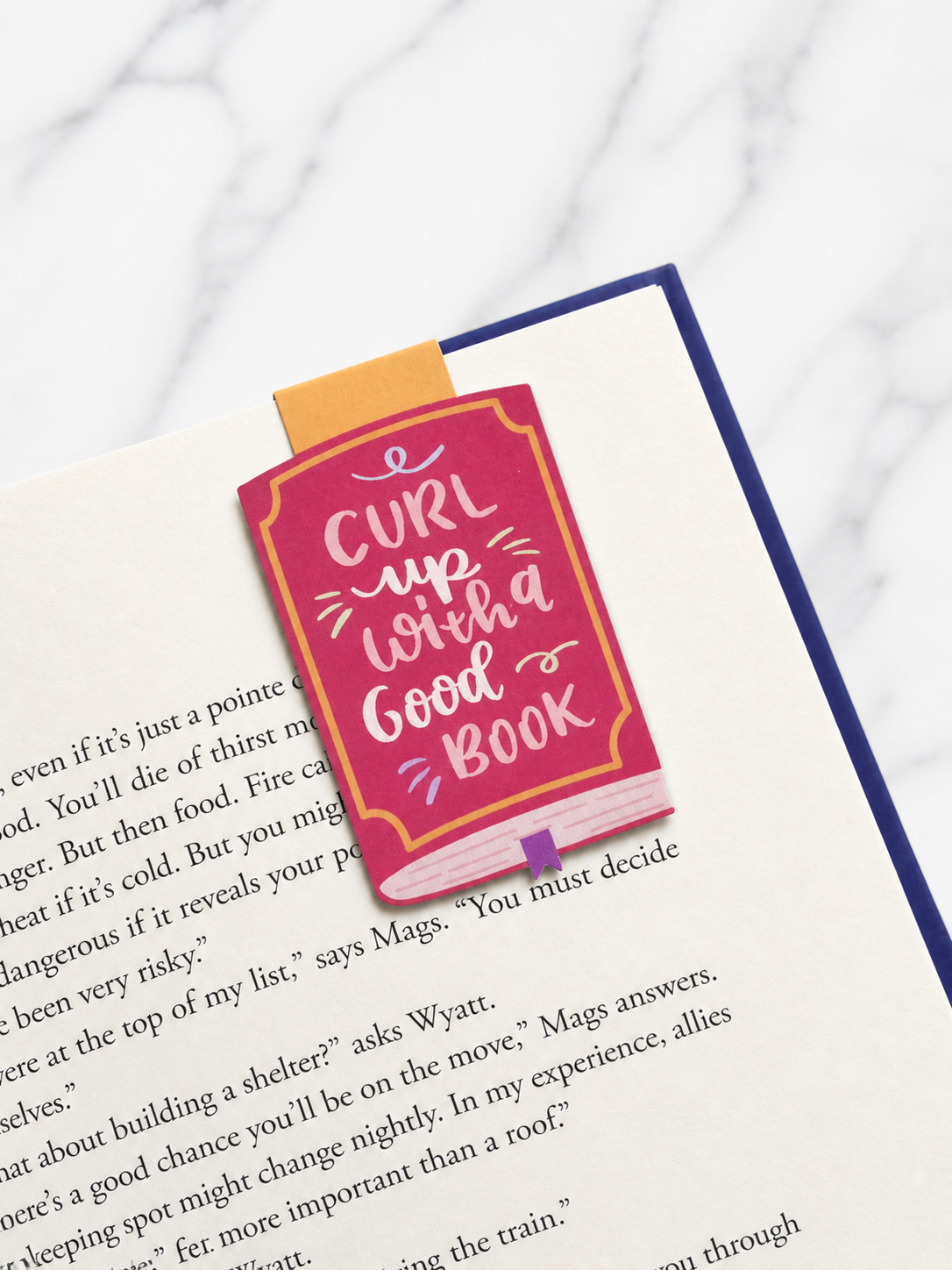 Quote magnetic bookmark clipped to book page showing secure hold