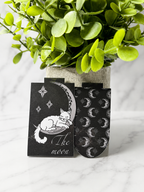 Celestial magnetic bookmark showing sleeping cat on moon design with matching moon and star patterned bookmark