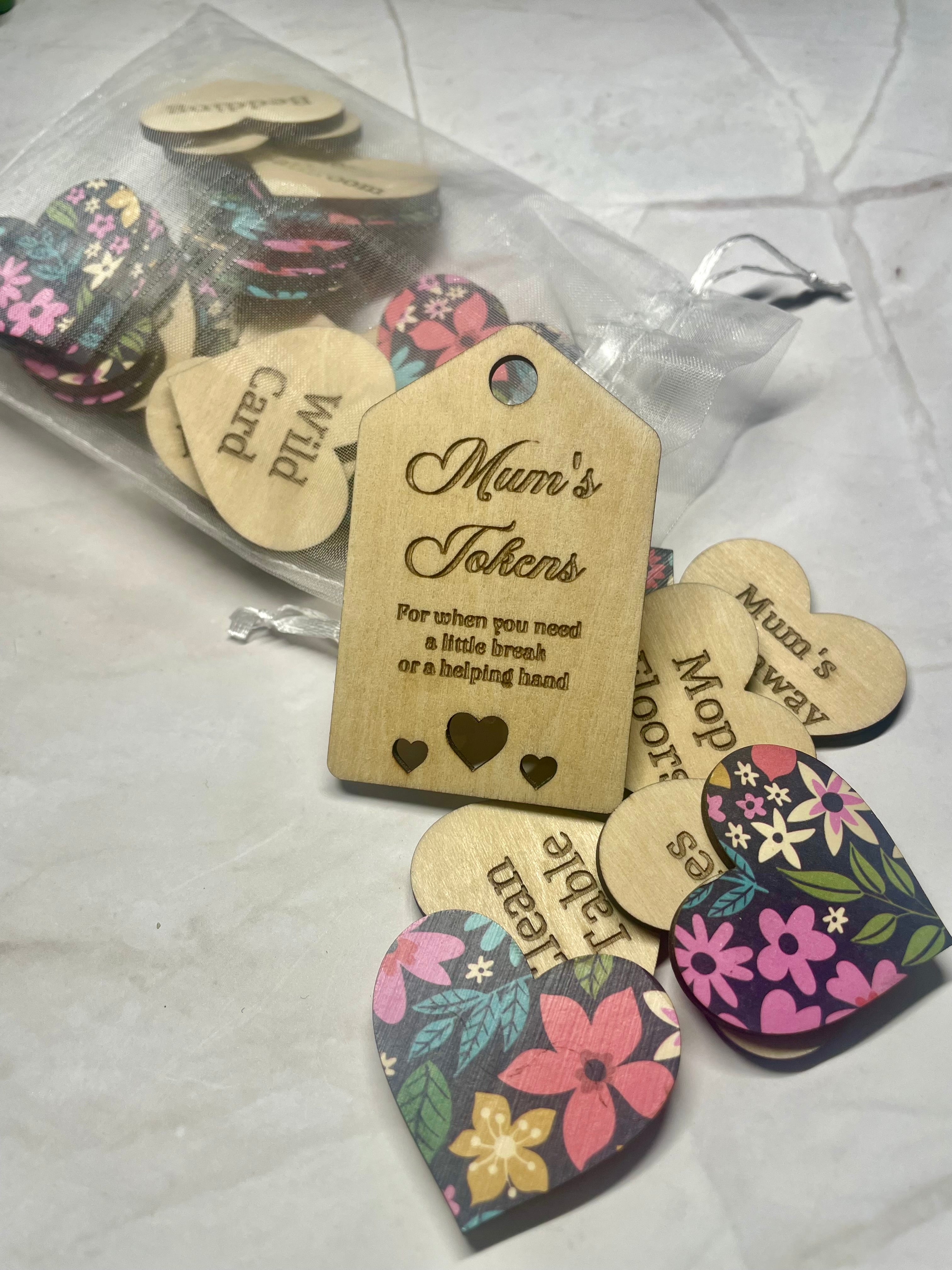 Wooden heart-shaped tokens with multicoloured floral design backing.