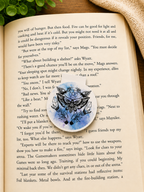 Moth and crystal magnetic bookmark placed on an open book 