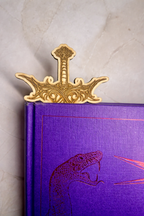 Decorative wooden sword in a purple book 
