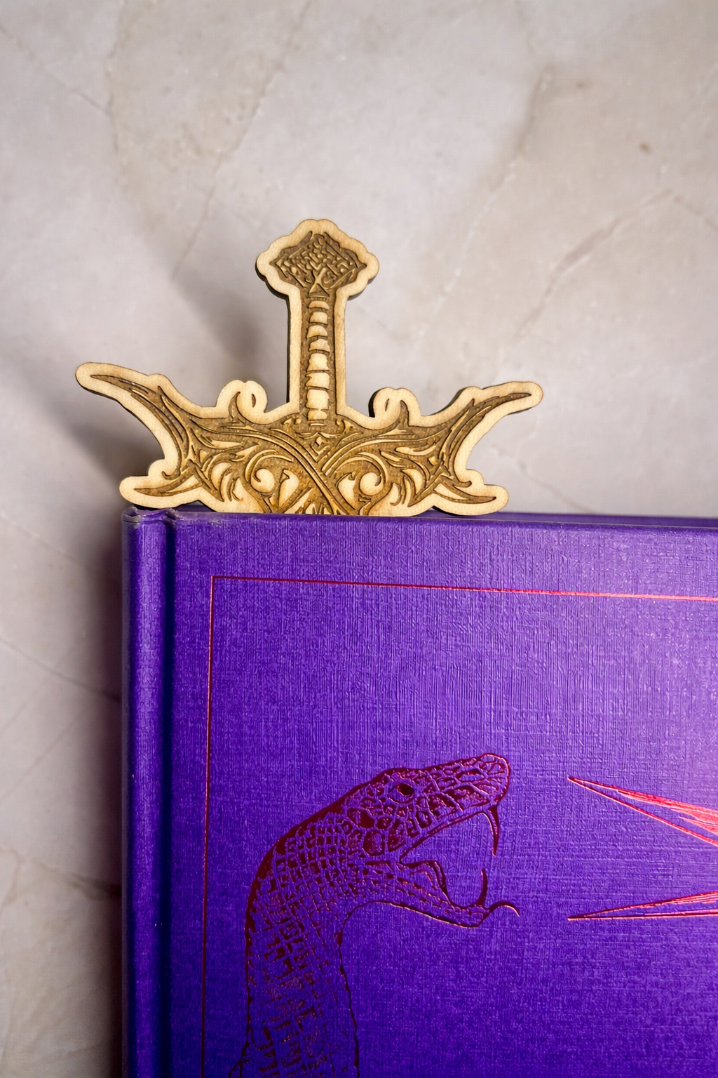 Decorative wooden sword in a purple book 