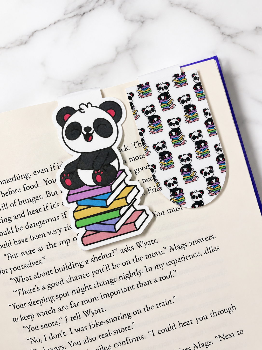 Two panda magnetic bookmarks clipped onto an open book demonstrating how they securely hold pages in place