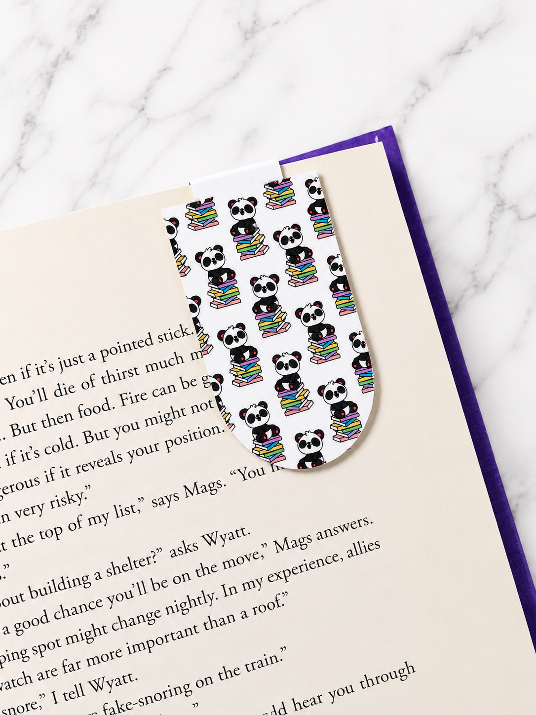 Pattern panda magnetic bookmark clipped onto a book page showing practical everyday use for readers