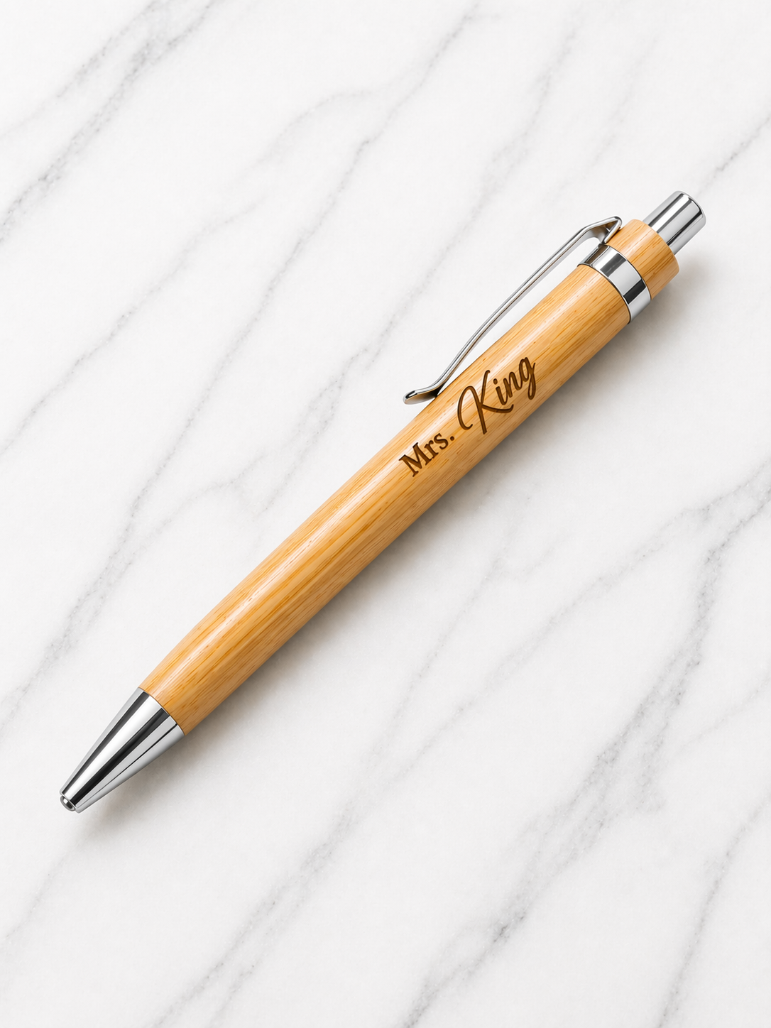 Personalised bamboo pen engraved with name Mrs King, custom teacher gift pen on marble background