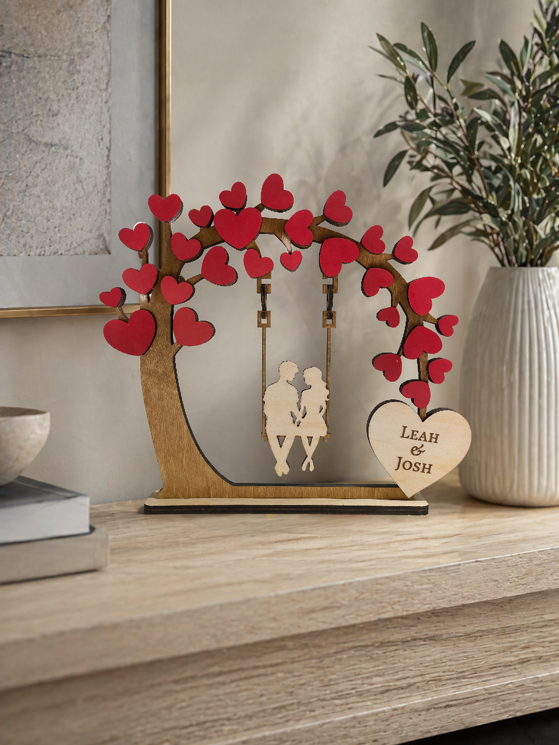 Wooden personalised tree swing ornament displayed on shelf in modern home setting