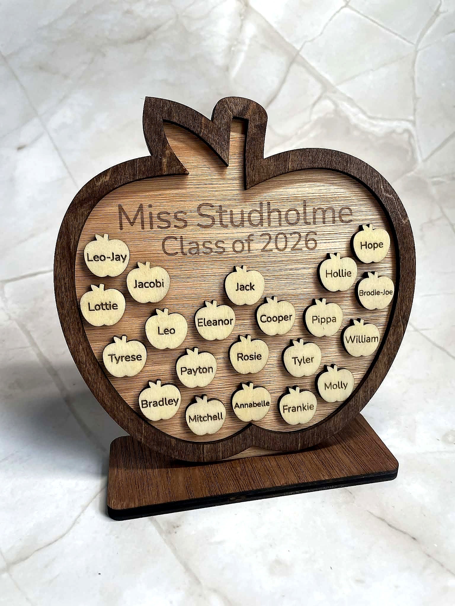 Front view of personalised wooden apple plaque engraved with teacher name and student names, classroom gift idea