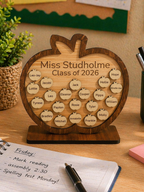 Personalised wooden apple plaque with student names displayed on a teacher’s desk, engraved class gift for end of year
