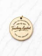 Personalised teaching assistant keyring engraved wooden thank you gift for TA on marble background