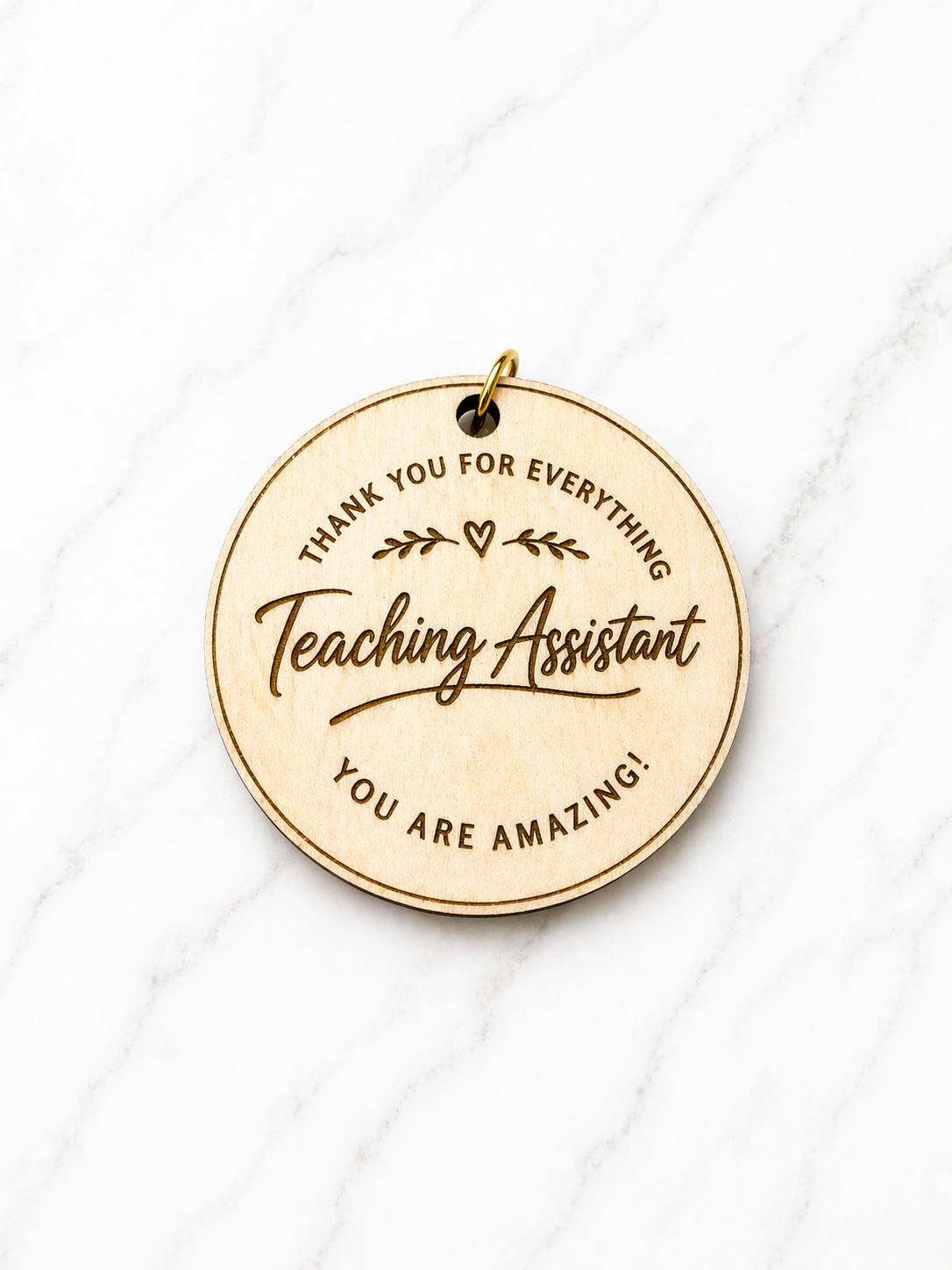 Personalised teaching assistant keyring engraved wooden thank you gift for TA on marble background