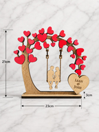 Personalised wooden couple tree swing ornament with heart design showing 23cm width and 21cm height dimensions