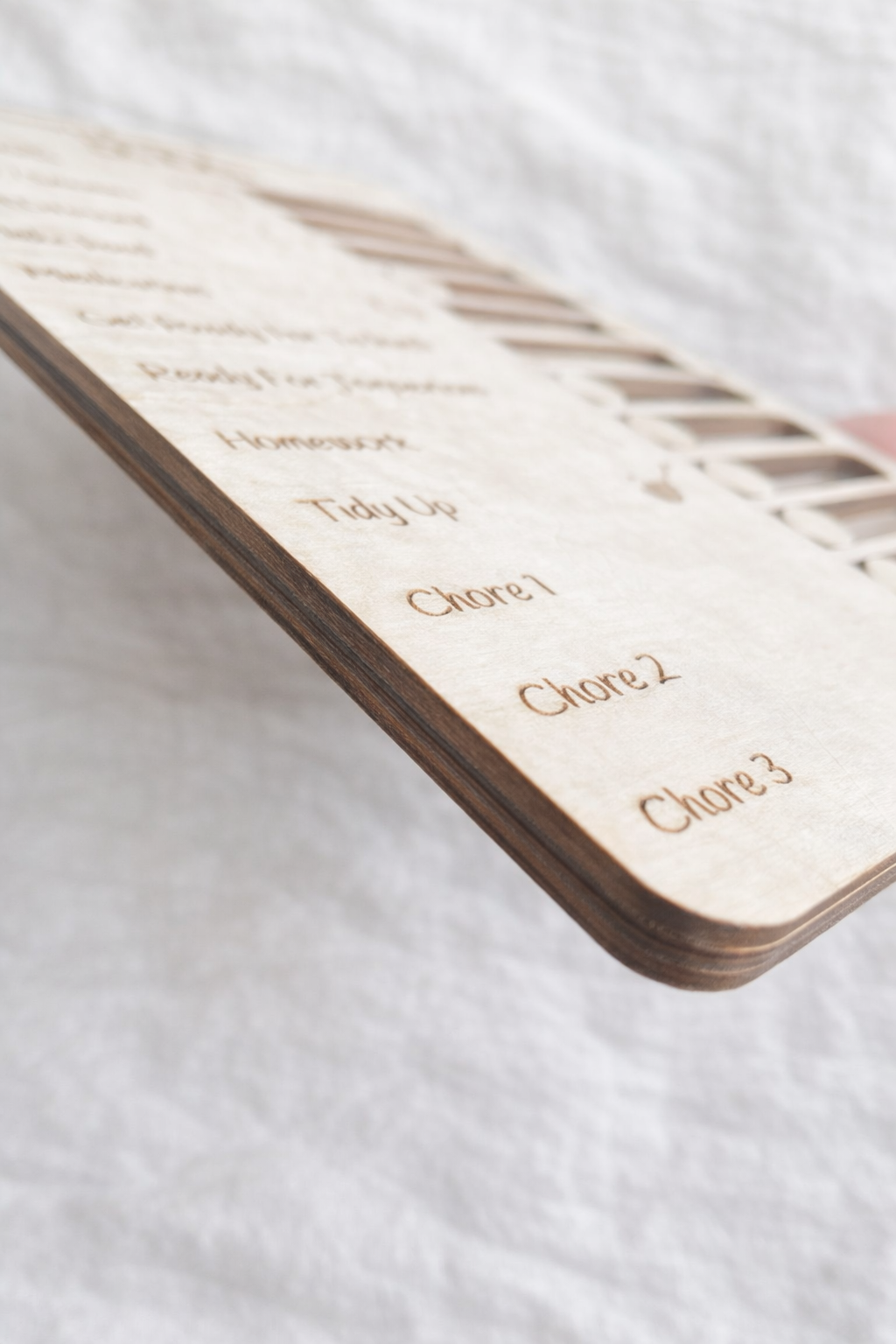 Personalised kids chore chart wooden board with sliders, showing side of the wood, children’s daily routine organiser gift displayed on white surface